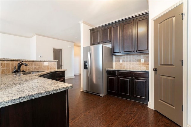 3175 Rock Port Cir, Norcross, GA 30092 - kitchen featuring stainless steel fridge with ice dispenser, a sink, decorative backsplash, dark brown cabinetry, and dark wood finished floors