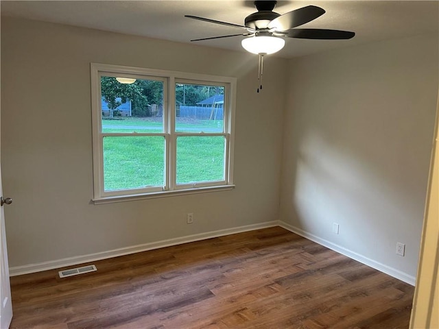 1321 Earle Ct SE, Conyers, GA 30013 - empty room with ceiling fan, dark wood-style floors, plenty of natural light, and baseboards