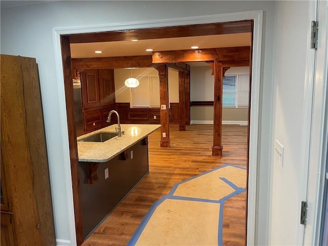 1321 Earle Ct SE, Conyers, GA 30013 - kitchen with a sink, wood finished floors, baseboards, decorative light fixtures, and beamed ceiling