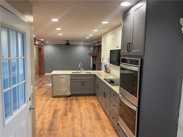 1321 Earle Ct SE, Conyers, GA 30013 - kitchen with black appliances, a sink, a peninsula, gray cabinets, and ceiling fan