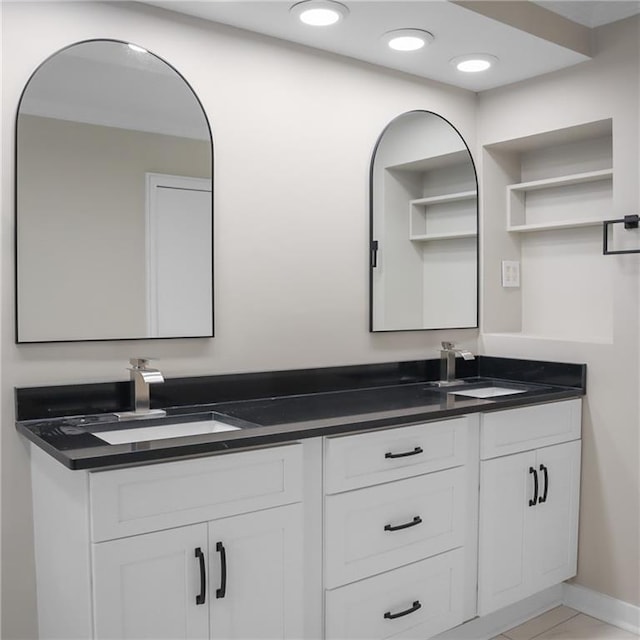 full bath featuring recessed lighting, a sink, baseboards, and double vanity