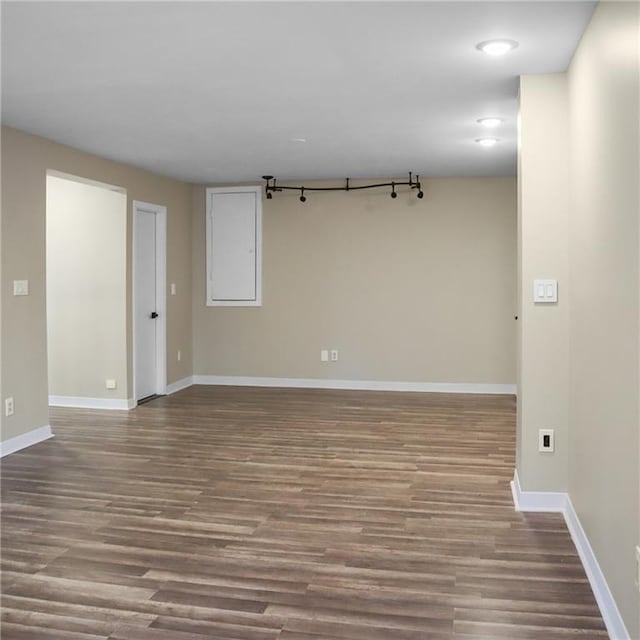 unfurnished room featuring wood finished floors and baseboards