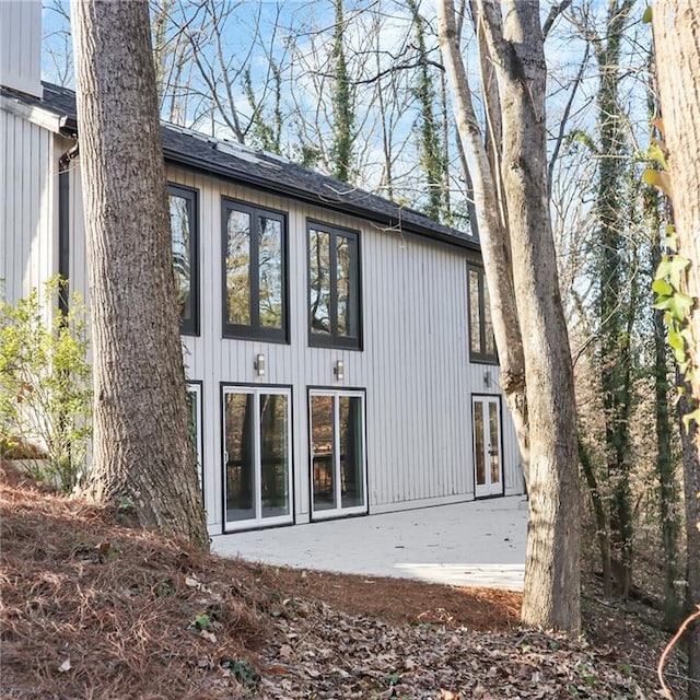 rear view of property featuring french doors and a patio area