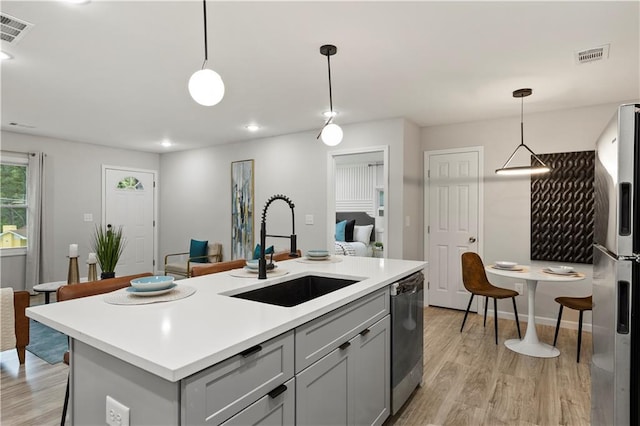 1770 Atherton Dr, Decatur, GA 30035 - kitchen with a sink, appliances with stainless steel finishes, gray cabinets, light wood finished floors, and recessed lighting