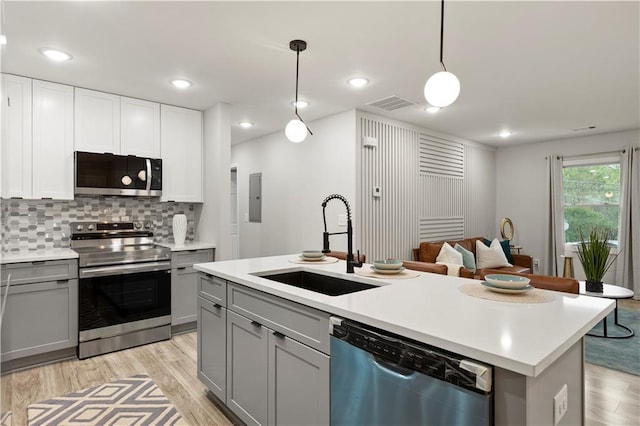 1770 Atherton Dr, Decatur, GA 30035 - kitchen featuring appliances with stainless steel finishes, a sink, gray cabinets, light wood finished floors, and recessed lighting