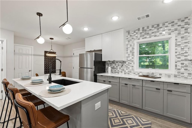 1770 Atherton Dr, Decatur, GA 30035 - kitchen featuring gray cabinetry, a sink, freestanding refrigerator, decorative backsplash, and recessed lighting