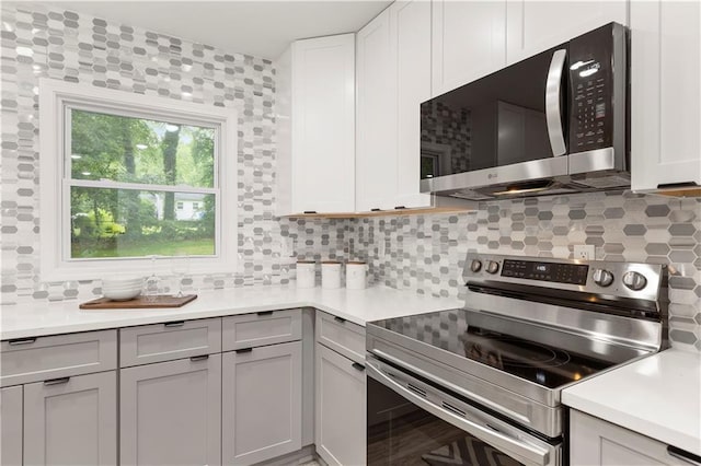 1770 Atherton Dr, Decatur, GA 30035 - kitchen with appliances with stainless steel finishes, backsplash, light countertops, and gray cabinetry