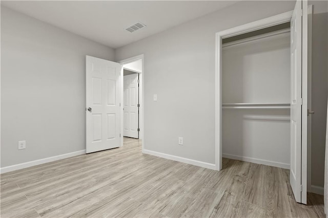 1770 Atherton Dr, Decatur, GA 30035 - unfurnished bedroom with light wood-style flooring, a closet, and baseboards