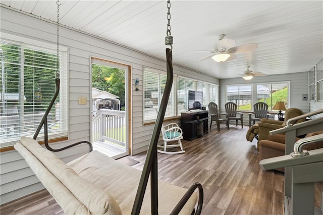 sunroom with ceiling fan and a healthy amount of sunlight