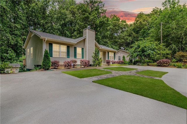 24 Arrow Ct, Lavonia, GA 30553 - view of front facade with a chimney, a lawn, and driveway