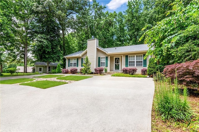 24 Arrow Ct, Lavonia, GA 30553 - ranch-style home with a chimney, concrete driveway, and a front lawn