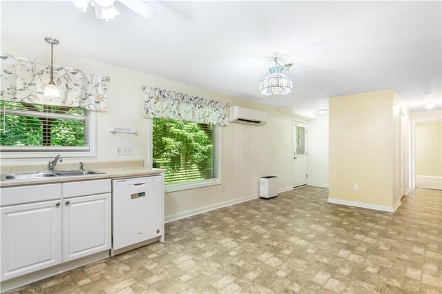 24 Arrow Ct, Lavonia, GA 30553 - kitchen featuring white dishwasher, a wall unit AC, pendant lighting, and white cabinetry