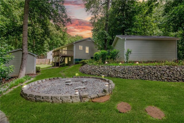 24 Arrow Ct, Lavonia, GA 30553 - yard at dusk featuring a yard, a wooden deck, stairs, and a storage shed