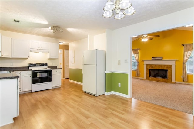 24 Arrow Ct, Lavonia, GA 30553 - kitchen with freestanding refrigerator, electric range, a textured ceiling, dark countertops, and white cabinetry