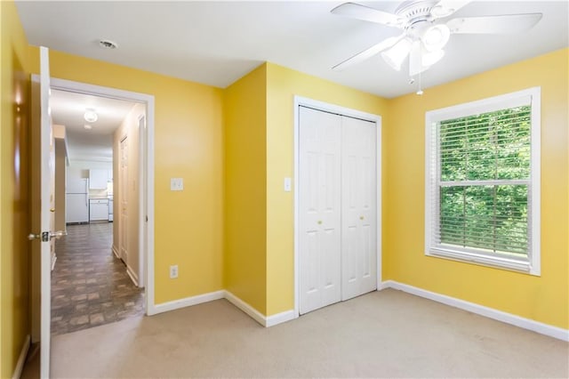 24 Arrow Ct, Lavonia, GA 30553 - unfurnished bedroom featuring freestanding refrigerator, a closet, carpet flooring, and a ceiling fan