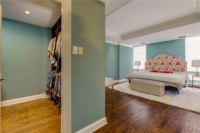 bedroom featuring hardwood / wood-style flooring and ornamental molding