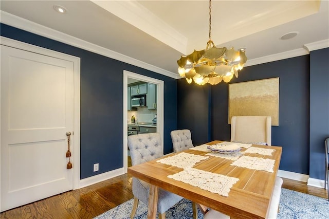 dining area with an inviting chandelier, dark hardwood / wood-style flooring, and ornamental molding