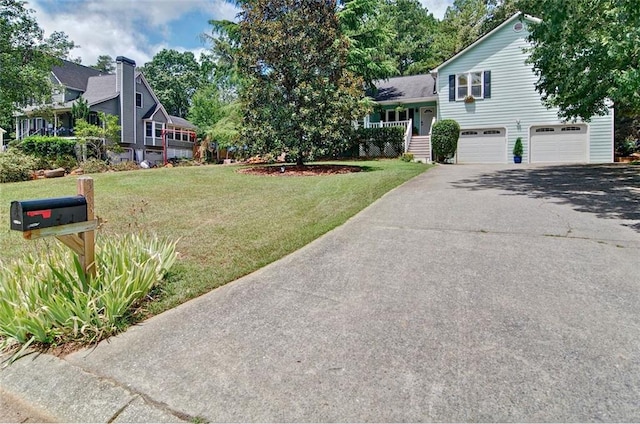 view of front facade featuring a garage, a porch, and a front lawn