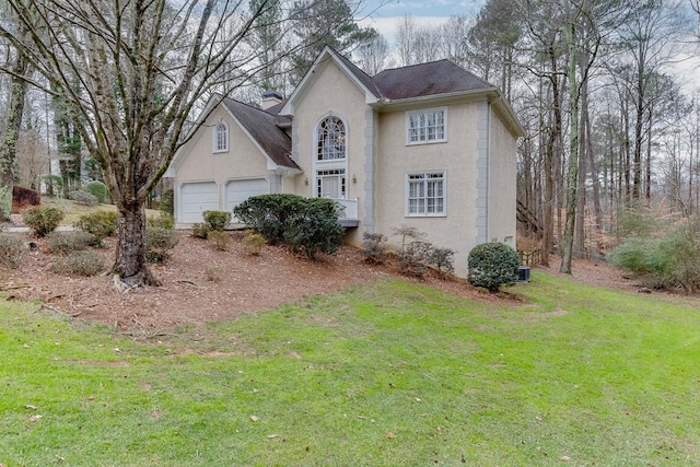 view of front of property with a front yard and a garage