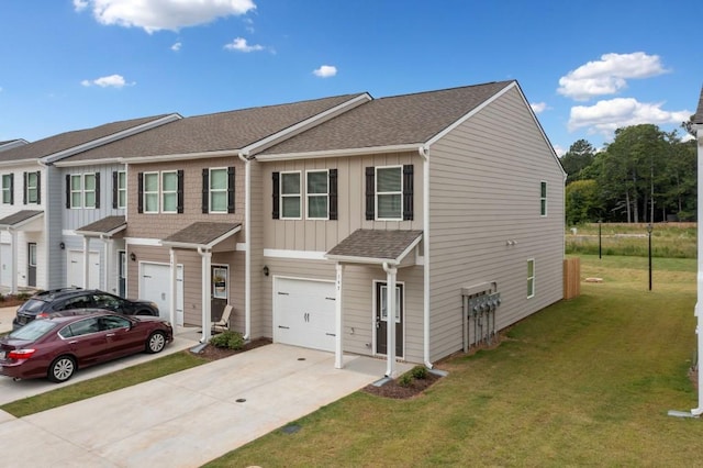 view of property with a garage and a front lawn