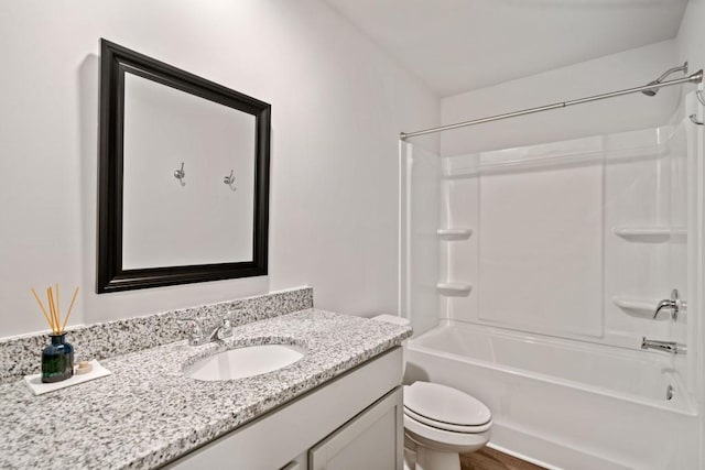 full bathroom with shower / tub combination, vanity, and toilet