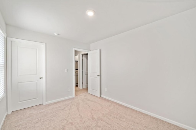 unfurnished bedroom with light carpet