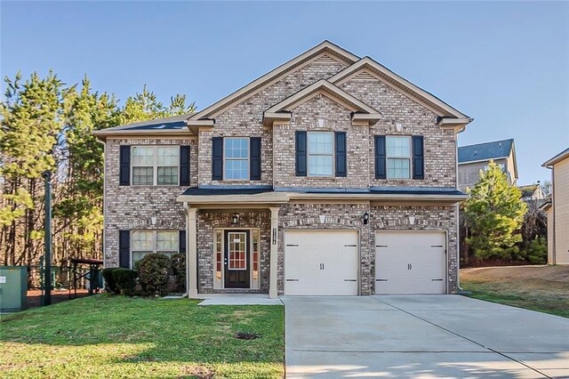 view of front of home with a front yard, an attached garage, brick siding, and concrete driveway