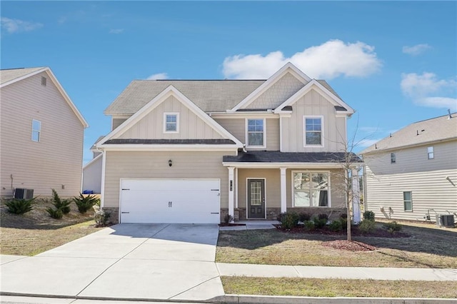 craftsman inspired home featuring a garage, stone siding, board and batten siding, and concrete driveway