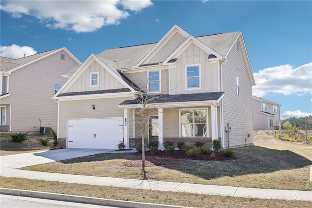 craftsman inspired home with a front lawn, board and batten siding, concrete driveway, and central AC