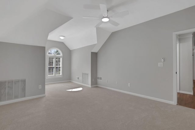 bonus room with lofted ceiling, visible vents, a ceiling fan, carpet flooring, and baseboards