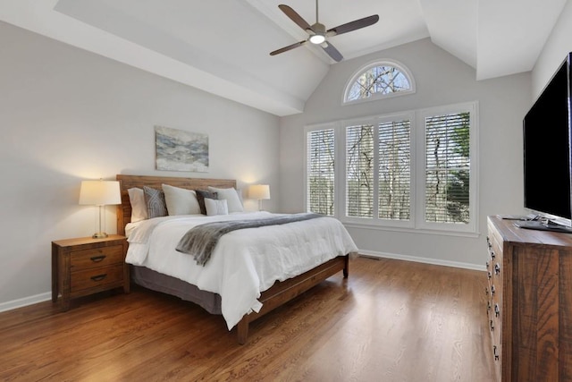 bedroom with lofted ceiling, ceiling fan, baseboards, and wood finished floors