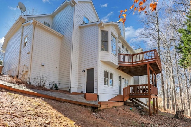 rear view of property featuring a deck