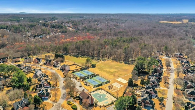 drone / aerial view with a residential view and a view of trees