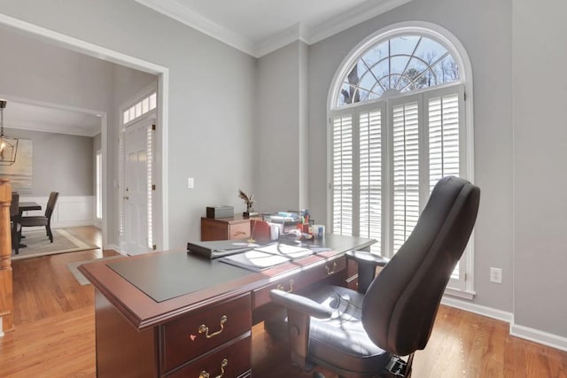 office area with light wood-type flooring and ornamental molding