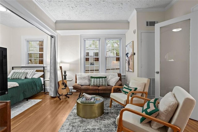 242 12th St NE Unit 14, Atlanta, GA 30309 - sitting room featuring ornamental molding, a textured ceiling, and wood finished floors