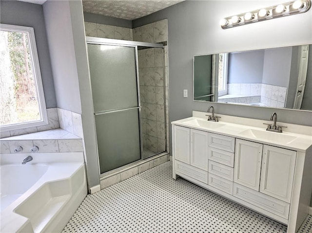 bathroom featuring a garden tub, a sink, and a shower stall