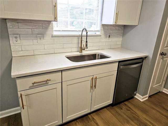 kitchen with dark wood finished floors, decorative backsplash, a sink, dishwasher, and baseboards