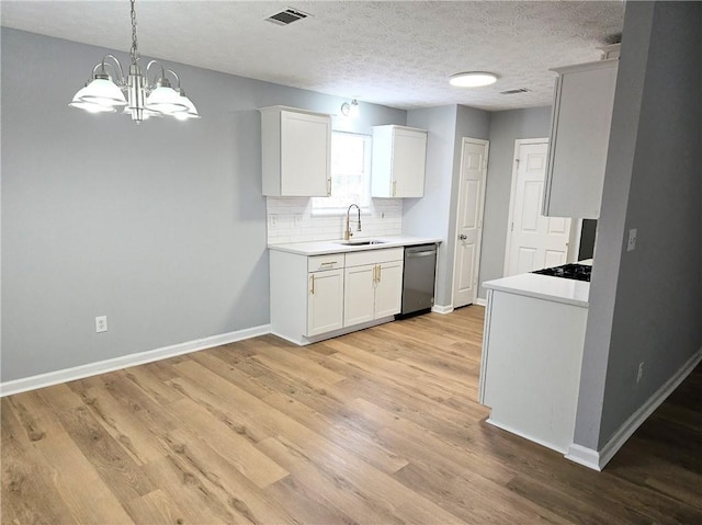 kitchen featuring visible vents, backsplash, a sink, light wood-type flooring, and dishwasher