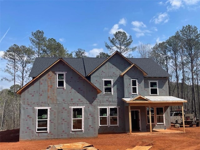 view of front of home featuring a porch and roof with shingles