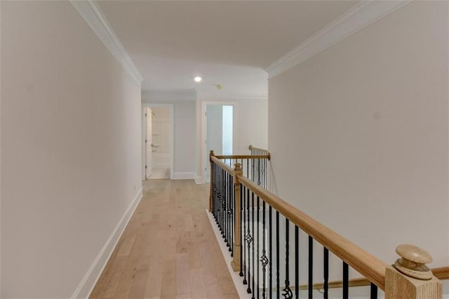 corridor featuring recessed lighting, an upstairs landing, baseboards, light wood-type flooring, and crown molding