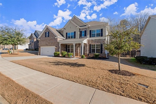 view of front of house featuring driveway, stone siding, a front lawn, and an attached garage