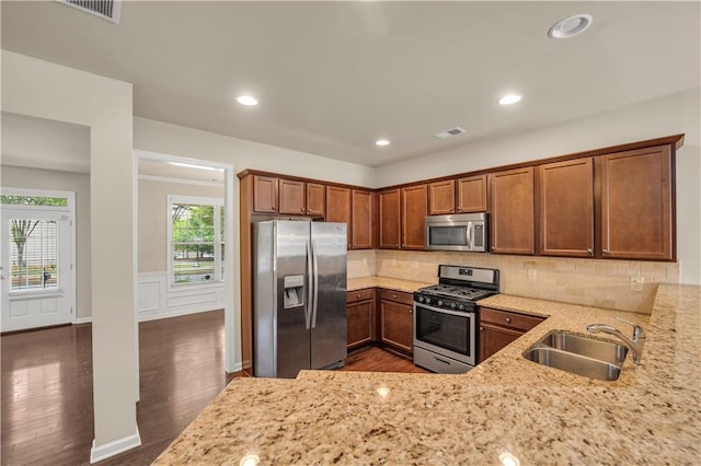 559 Myrle Trace Ln, Suwanee, GA 30024 - kitchen with appliances with stainless steel finishes, a sink, light stone counters, dark wood-type flooring, and recessed lighting