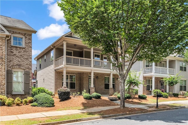 559 Myrle Trace Ln, Suwanee, GA 30024 - view of front facade with a balcony and brick siding