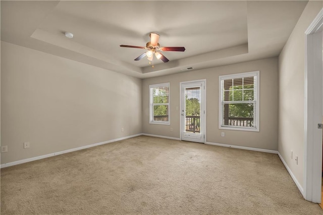 559 Myrle Trace Ln, Suwanee, GA 30024 - carpeted empty room with a raised ceiling, ceiling fan, baseboards, and a smoke detector