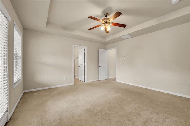 559 Myrle Trace Ln, Suwanee, GA 30024 - unfurnished bedroom with a tray ceiling, light carpet, baseboards, and ensuite bathroom
