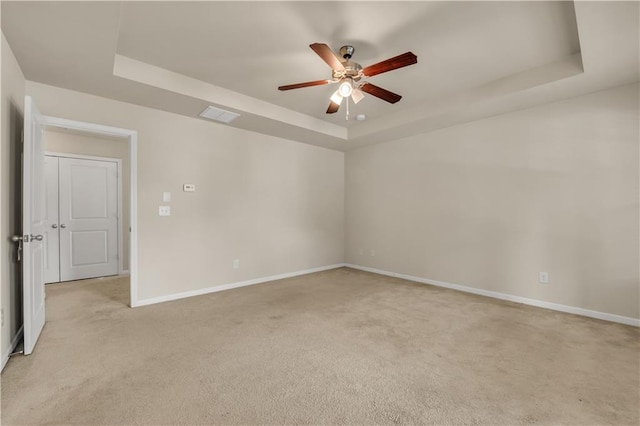 559 Myrle Trace Ln, Suwanee, GA 30024 - unfurnished room featuring a tray ceiling, light carpet, ceiling fan, and baseboards