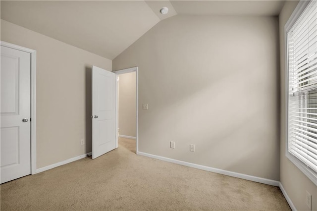 559 Myrle Trace Ln, Suwanee, GA 30024 - unfurnished bedroom featuring light carpet, lofted ceiling, multiple windows, and baseboards