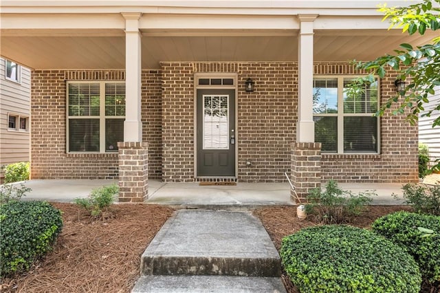 559 Myrle Trace Ln, Suwanee, GA 30024 - doorway to property featuring a porch and brick siding