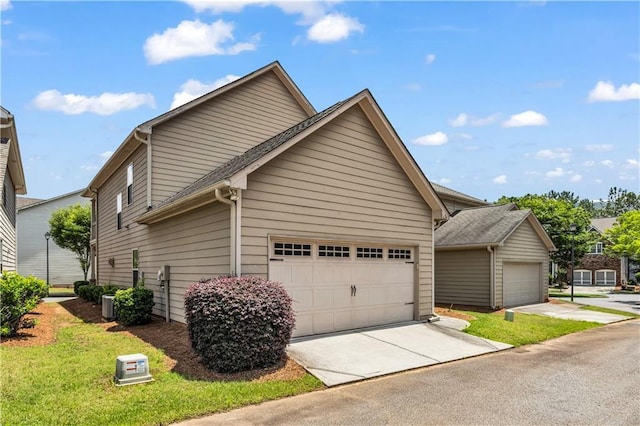 559 Myrle Trace Ln, Suwanee, GA 30024 - view of home's exterior with concrete driveway, central air condition unit, and an attached garage