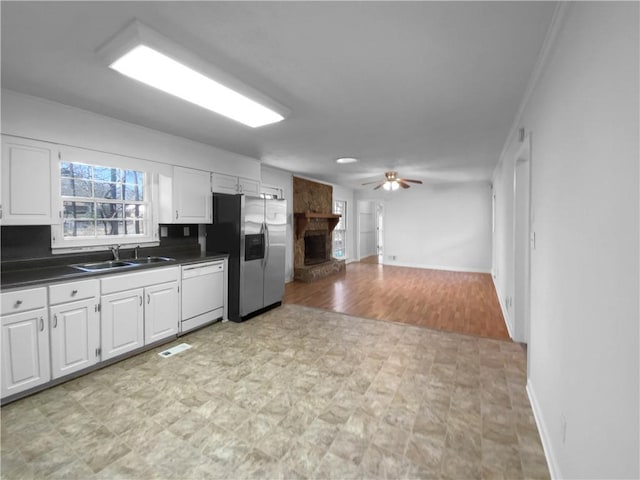 8005 Bamby Ln, Jonesboro, GA 30236 - kitchen with a sink, white cabinetry, dishwasher, dark countertops, and stainless steel fridge
